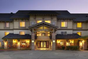a large house with its lights on at Larkspur Landing Folsom-An All-Suite Hotel in Folsom