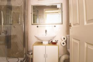 a bathroom with a sink and a shower at The Black Bull inn in Wooler +30 photos