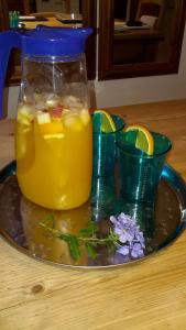 a glass pitcher of lemonade on a plate with at La Pantoufle Verte in Montauriol