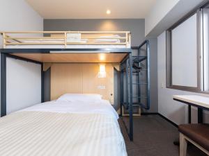 a bedroom with a bunk bed and a desk at Super Hotel Nara Shin Omiya Ekimae in Nara