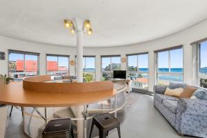 a living room with a table and a couch at The Rotunda, Gerroa in Gerroa