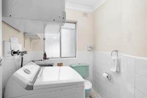 a white bathroom with a sink and a toilet at The Rotunda, Gerroa in Gerroa +31 photos