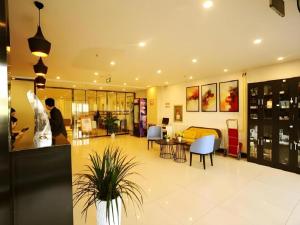 eine Lobby eines Ladens mit Tischen und Stühlen in der Unterkunft Jinjiang Inn JiNan Daminghu New Scenic Area Lishan Road in Jinan