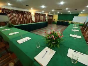 a conference room with a long table with a green table cloth at Lucky Star Hotel in Phnom Penh
