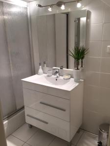 a white bathroom with a sink and a mirror at Villa Saint-Georges in Vesoul +21 photos