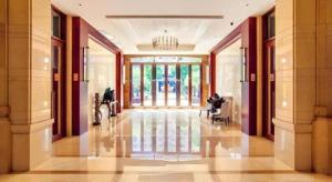 a hallway with a person sitting in a chair in a building at Hainan Yatai Hot Spring Hotel in Haikou +272 photos
