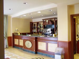 a bar in a restaurant with a clock on it at Hotel San Giorgio in San Nicola Arcella