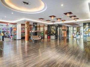 an empty shopping mall with a wooden floor and a large room at Kingreal seaview resort sanya in Sanya +277 photos