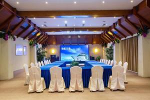 a conference room with a blue table and white chairs at Shenzhen Dameishawan Youtinghui Hotel in Shenzhen +276 photos