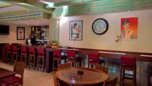 a bar with chairs and a clock on the wall at Oakland Hotel in Rayfūn