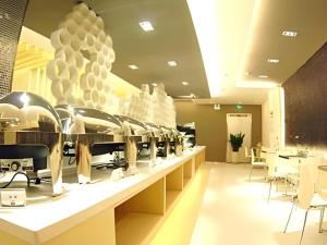 a store with a counter with a lot of shoes on display at Jinjiang Inn Taiyuan Longtan Park in Taiyuan