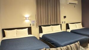 a room with two beds in a hospital room at GRAND BASE Hakataminami in Fukuoka