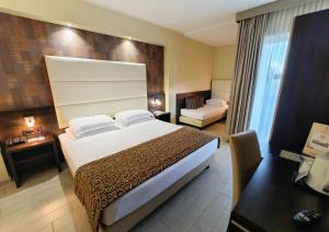 a hotel room with a large bed and a couch at Hotel Pineta Palace in Rome