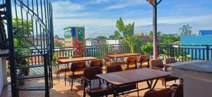 a patio with tables and chairs on a balcony at Domi Hotel in Siem Reap