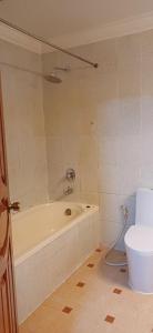 a bathroom with a bath tub and a toilet at Domi Hotel in Siem Reap