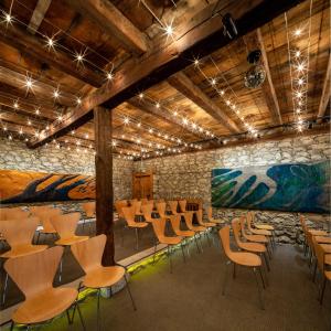 a room with chairs and tables and a stone wall at Gulevi Safranbolu Heritage Hotel in Safranbolu