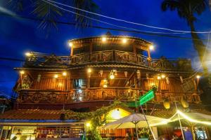 an old building with lights on it at night at Green Ocean Koh Rong in Koh Rong Island