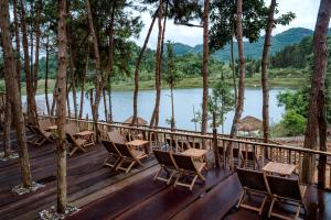 a deck with chairs and a view of a river at Balana HaGiang in Làng Lap