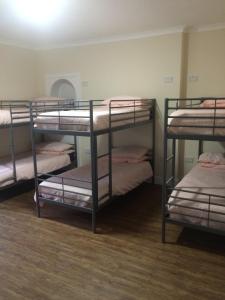 a group of bunk beds in a room at Edinburgh West Side Hostel in Edinburgh