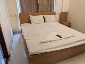 Ένα ή περισσότερα κρεβάτια σε δωμάτιο στο Collection O Dattapukur Railway Terminal Kolkata