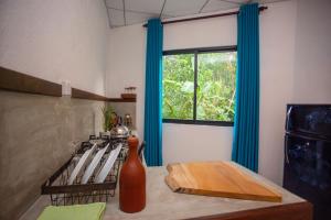 a kitchen with a table with a cutting board and a window at Amora Villa in Galle