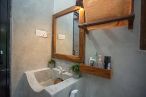 a bathroom with a sink and a mirror at Amora Villa in Galle +23 photos