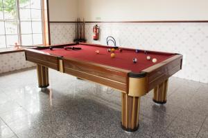 a pool table with balls on it in a room at Residencial O TRINDADE in Águeda