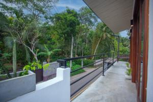 a balcony of a house with trees in the background at Amora Villa in Galle