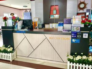 a reception counter in a store with a woman behind it at Lake Terrace Resort in Ban Pak Ba Ra +163 photos