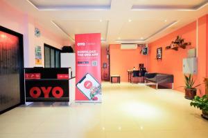 an office lobby with orange walls and a sign at Fewtor Place in Hua Thanon Beach