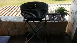 a black grill sitting on a stone wall at Luxurious Stone House in Elani in Siviri
