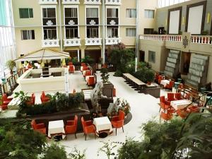 an empty courtyard of a hotel with tables and chairs at Lhasa Hotel in Lhasa