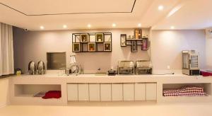 a kitchen with a counter with two machines on it at City Comfort Inn Nanning Guangxi University Xiuling Road Metro Station in Nanning
