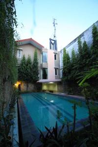 a large swimming pool in front of a building at Sanur Ayu Hotel in Sanur