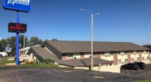 ein Gebäude mit einem Schild neben einem Parkplatz in der Unterkunft Americas Best Value Inn Beatrice in Beatrice