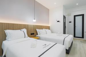 Ένα ή περισσότερα κρεβάτια σε δωμάτιο στο Edenwood Hotel