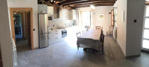 a kitchen with a long table and a kitchen with a counter at Adipe in Cilveti