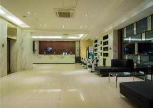 a lobby with couches and chairs in a building at City Comfort Inn Liuzhou Beique Road Huang Village in Liuzhou