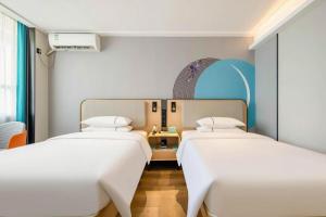 Postel nebo postele na pokoji v ubytování City Comfort Inn Nanning Guangxi University + 202 fotografií