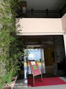 a pink sign sitting in front of a building at Castle Dreams Hotel in Daliao