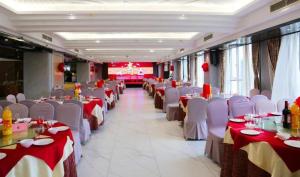 einen Bankettsaal mit Tischen und Stühlen sowie einem roten und weißen Tischtuch. in der Unterkunft Liwan International Hotel Chengdu in Chengdu