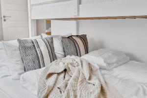 a white bed with a blanket on top of it at Fjellvangvegen 11 by Vacation Trysil in Trysil