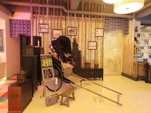 a room with a chair in a store at Dalian Household Theme Hotel Huanghe Road Branch in Dalian