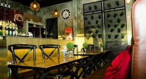 a dining room with a wooden table and chairs at The Prince Hotel in Campson