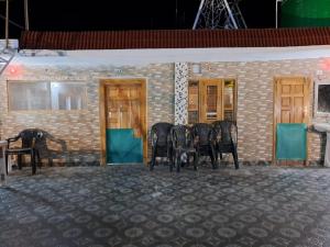 un groupe de chaises assises devant un bâtiment dans l'établissement Gopi Homestay & Restaurant - Jim Corbett, à Tota Ām 6 autres photos