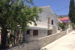 a stone wall in front of a white house at Guest house Perfect Location in Bol