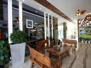 a lobby with chairs and a table and a table sidx sidx sidx at Mango Sea View Hotel in Sanya