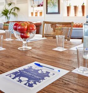 a wooden table with a bowl of apples on it at Delamar 4*Sup-Adults only (18+) in Lloret de Mar