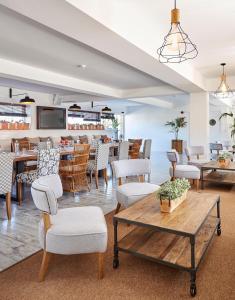 a dining room with tables and chairs and a restaurant at Delamar 4*Sup-Adults only (18+) in Lloret de Mar