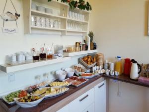ein Buffet mit vielen Speisen auf der Theke in der Unterkunft Pension Nordsee in Norddeich + 9 Fotos